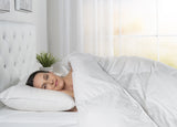 women sleeping on bed with pillow and comforter